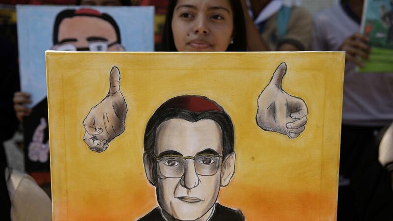 A youth holds a portrait of Archbishop Oscar Romero after the Vatican’s announcement that he will be canonised. The archbishop was assassinated in El Salvador in 1980.  Photograph: Rodrigo Sura/EPA