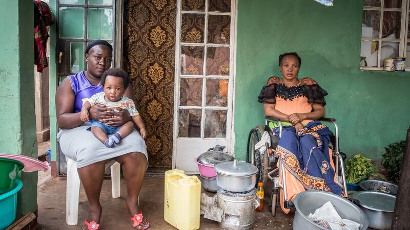 Nyongonye Bridget, 50, with her daughter-in-law and grandchild at their two-room home in ‘Congo Quarter’, Kampala, Uganda. They have been given one week to move out, after failing to pay rent during the coronavirus lockdown. Photograph: Sally Hayden