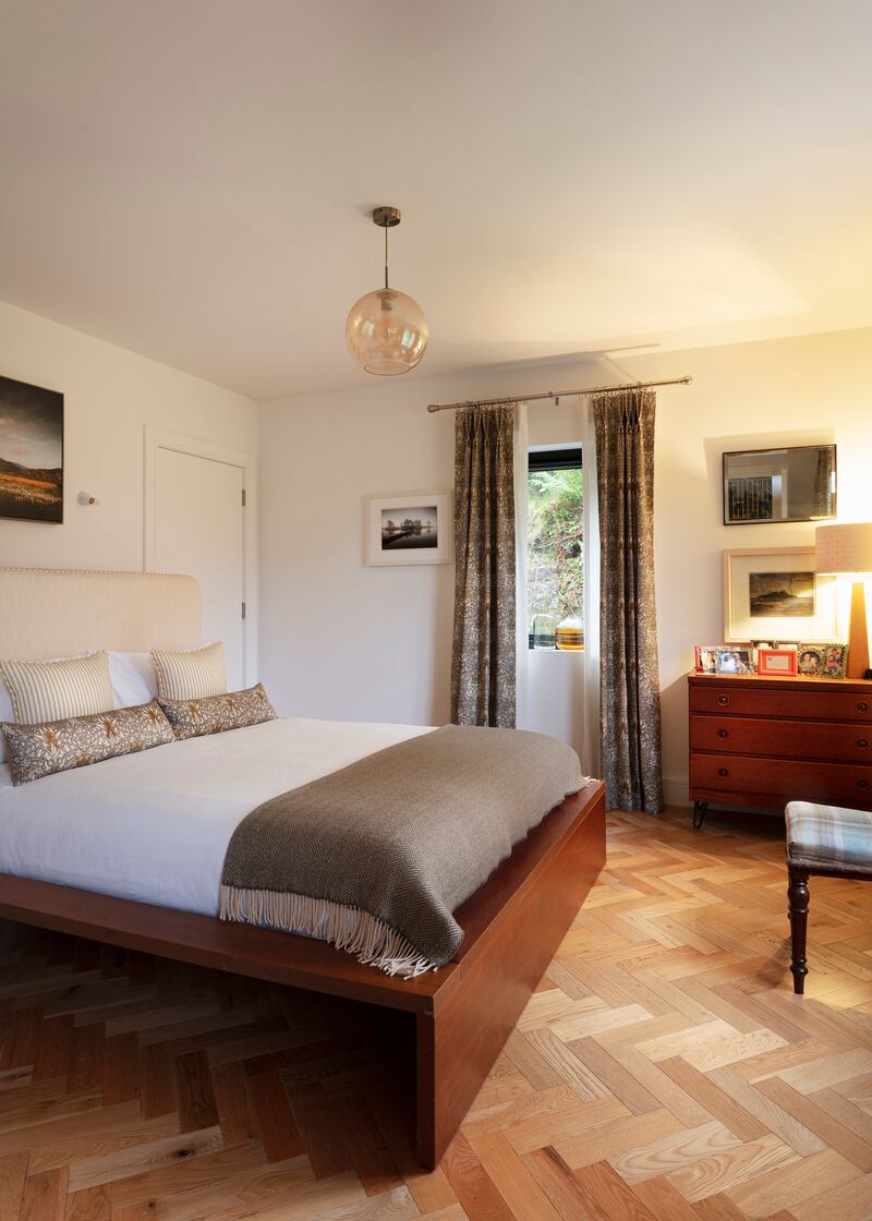 The Habitat bed in the principal bedroom had been in Eamonn’s parents’ shed since 2008 as it didn’t fit in their rental homes. Liz made the headboard, designing it to conceal a shelf behind for books and other bedside items as there wasn’t room for lockers either side of the bed. Photograph: Lynda Kenny