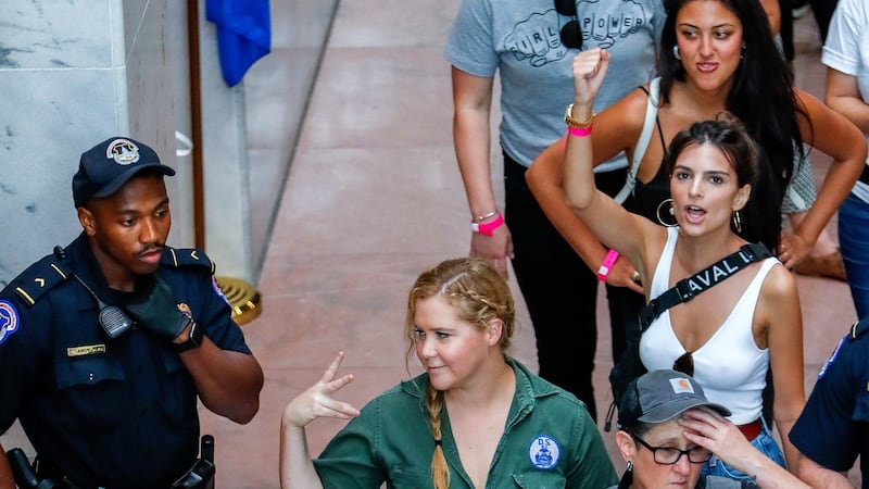 US comedian Amy Schumer (centre) and US actress Emily Ratajkowski (right) gesture after getting detained along with hundreds of other protestors against the confirmation of Supreme Court nominee Judge Brett Kavanaugh. Photograph: EPA