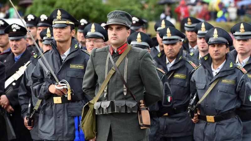 A soldier in historical army outfit stands alongside Italian Finance Police as Pope Francis celebrates a solemn mass at the war memorial at Fogliano Redipuglia. Photograph: Daniel Dal Zennaro/EPA