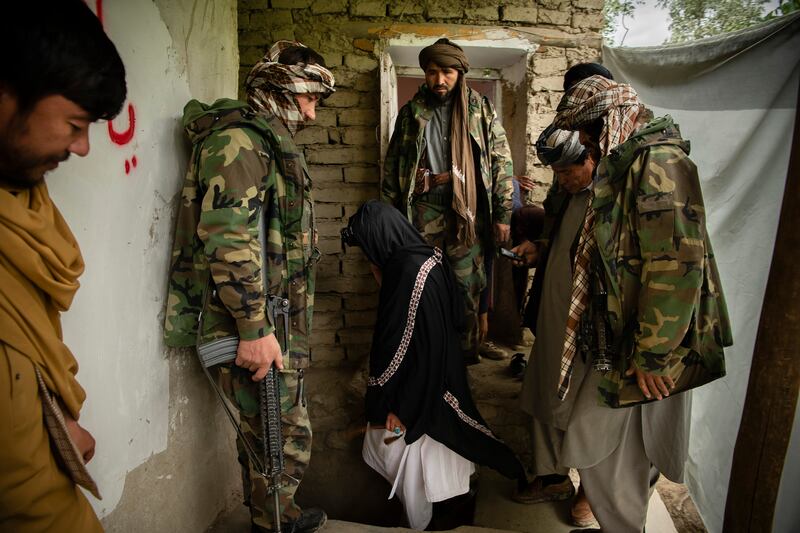 Mawlawi Mahdi Mujahid (centre) surrounded by his fighters at his headquarters in Balkh Aab.Photograph: Kiana Hayeri/New York Times