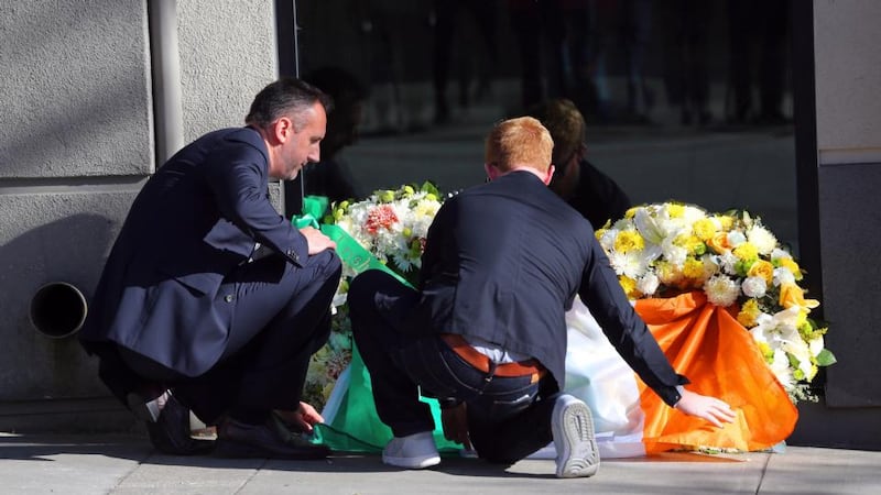 Philip Grant, Ireland’s Consul General in San Francisco, and Neil Sands of the Irish Network Bay Area place an Irish flag at the scene of the balcony collapse at Library Gardens Apartments in downtown Berkeley. Photograph: Jim Wilson/The New York Times