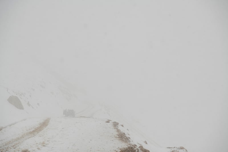 Snow covers a road on Qom Kotal mountain in Afghanistan, June 21, 2022. In northern Afghanistan, hundreds of Shiite Muslims joined an uprising led by a former Taliban commander. (Kiana Hayeri/The New York Times)