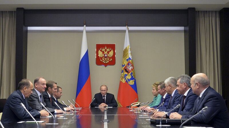 Russian president Vladimir Putin (C) chairs a meeting with members of the security council at the Novo-Ogaryovo state residence outside Moscow, Russia. Photograph: Alexei Druzhinin/RIA Novosti/Kremlin/Reutes