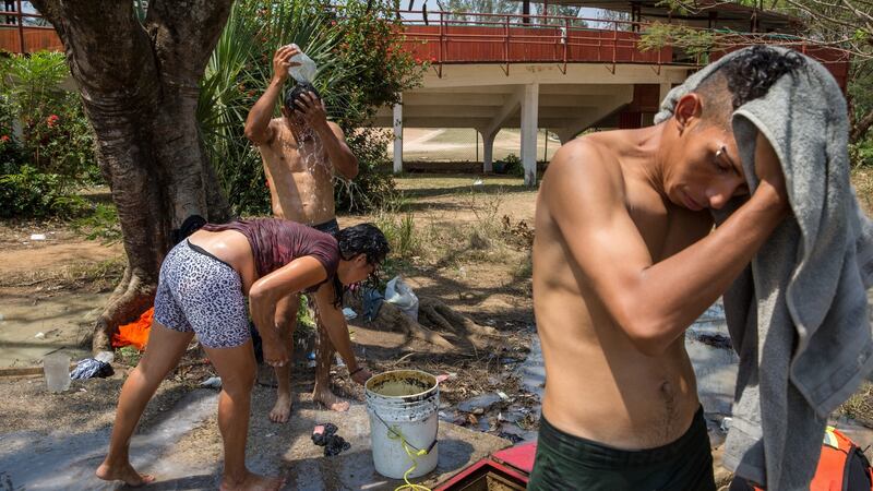 Migrants wash up at a temporary camp in Matías Romero. Photograph: Brett Gundlock/The New York Times