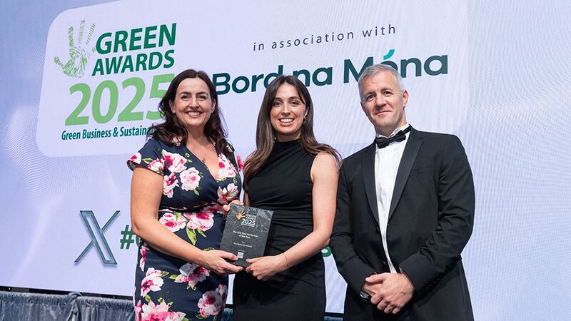 Seána Carty, sustainability associate, presents The ESG best performer of the year to Anne Moore and Ronan Walsh,  Gas Networks Ireland.
