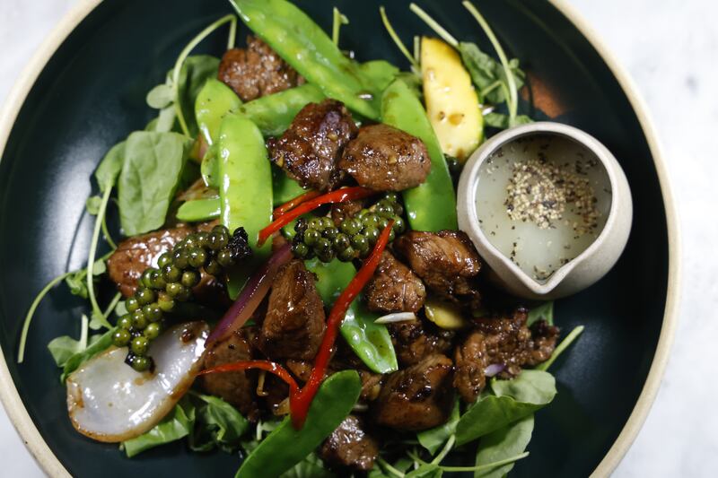 Indochine's 'Shaking Beef': pineapple marinated Irish fillet, mirin, Shoaxing and light soy sauce, with mange tout and courgette on baby watercress. Photograph: Nick Bradshaw