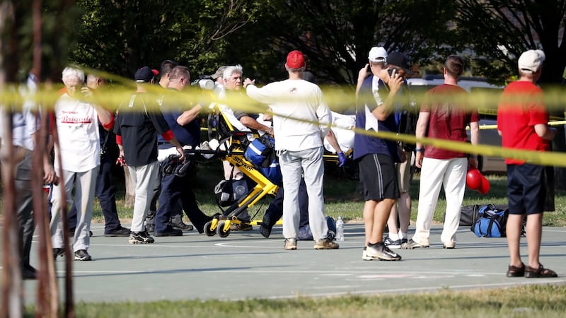 A person is loaded on to a stretcher as members of the Republican congressional baseball team look on following a shooting in Alexandria, Virginia on Wednesday.  Photograph: Shawn Thew/EPA