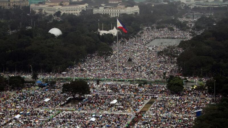 A handout photo provided by the Philippine Air Force Public Information Office shows aerial shot of devotees during a downpour of rain waiting for the arrival of Pope Francis to celebrate a mass in Manila. Photograph: EPA