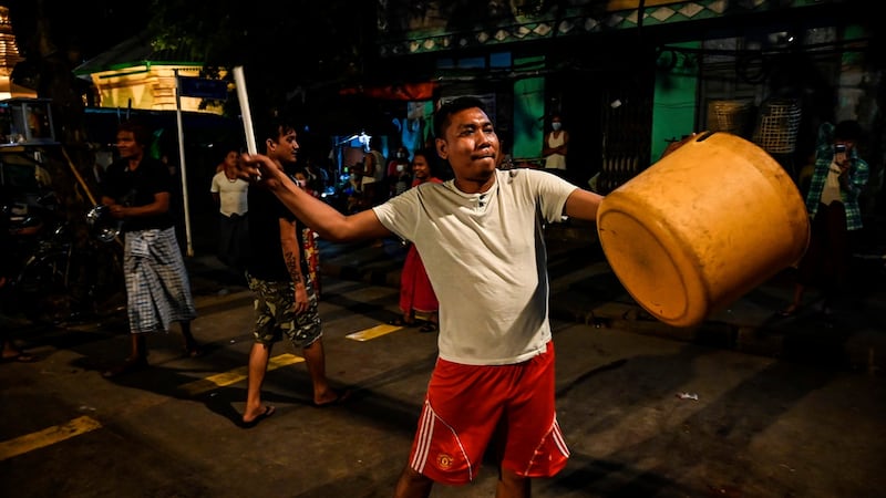 A man hits a plastic container to make noise after calls for protest went out on social media in Yangon on February 3rd. Photograph: STR/AFP via Getty Images