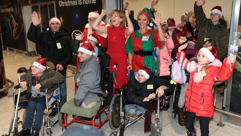 Adi Roche (centre) with children from Belarus as they arrived at Dublin Airport , including Igor Shadzkou (front right).  Photograph: Brian McEvoy