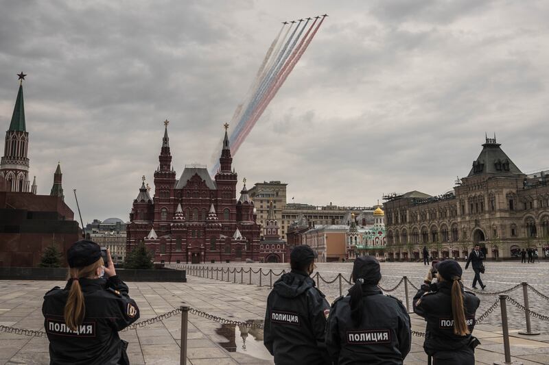 Russian police officers watch military aircrafts fly over the Kremlin in Moscow in 2020. A huge influx of munitions is needed to keep Russia’s air force from changing the course of the war, according to US officials and newly leaked Pentagon documents. Photograph: Sergey Ponomarev/New York Times
                      