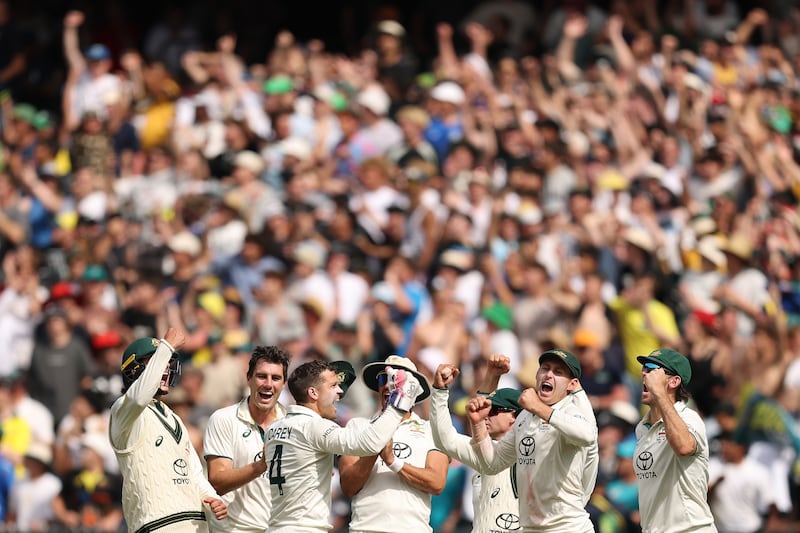 Pat Cummins of Australia celebrates with team-mates after taking the wicket of India's Yashasvi Jaiswal on day five at the MCG. Photograph: Robert Cianflone/Getty Images