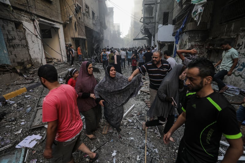 People react at the site of an Israeli rocket attack in Al-Shati refugee camp on October 14th. Photograph: Mohammed Saber: EPA