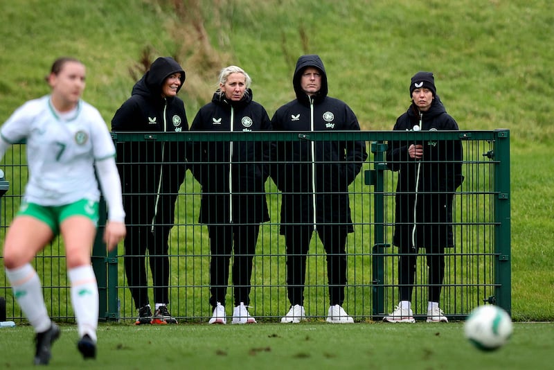 Republic of Ireland head coach Carla Ward (second from left) watching a game between Ireland's under-19s and a development squad at the FAI's National Training Centre on Wednesday, alongside her assistants Emma Byrne, Alan Mahon and Amber Whiteley. Photograph: Ryan Byrne/Inpho