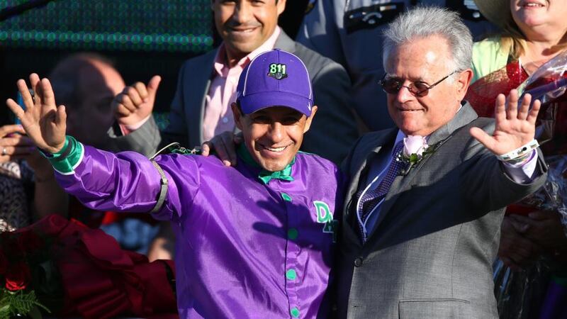 Jockey Victor Espinoza (left) and trainer Art Sherman (right) celebrate in the winners circle after guiding California Chrome to victory  in  the 140th  Kentucky Derby at Churchill Downs in Louisville, Kentucky. Photograph:  Andy Lyons/Getty Images