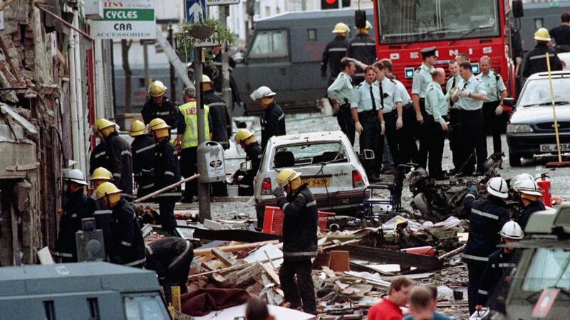 Police officers and firefighters inspect the damage caused by a bomb explosion in Market Street, Omagh on August 15th, 1998. Photograph: Paul McErlane/PA Wire