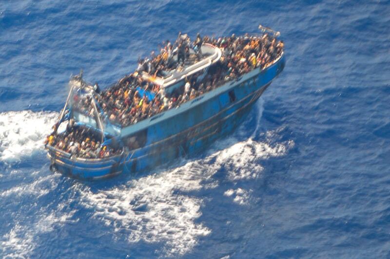 This undated handout image provided by Greece’s coast guard on Wednesday shows scores of people on a battered fishing boat that later capsized and sank off southern Greece (Hellenic Coast Guard/AP)