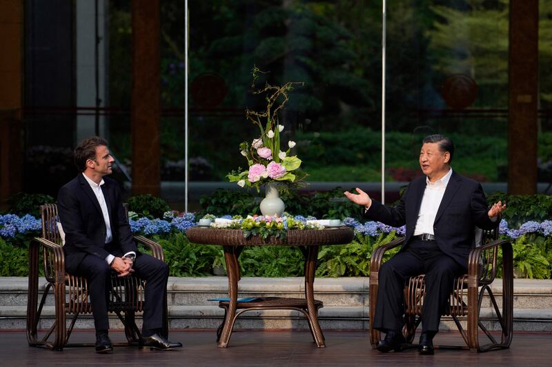 Chinese president Xi Jinping and French president Emmanuel Macron attend a tea ceremony in Guangzhou. Photograph: Thibault Camus / POOL / AFP