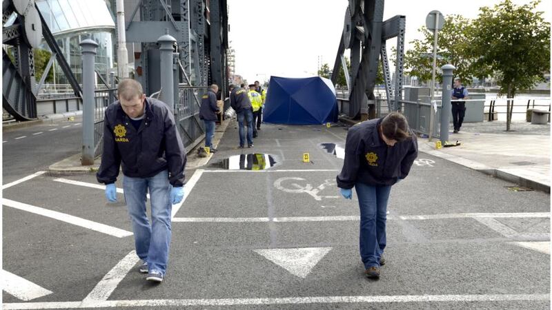 Gardai search the scene of this morning’s fatal crash at  North Wall Quay  in Dublin city centre. Photograph: Brenda Fitzsimons/The Irish Times