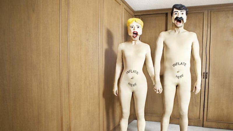 ‘Sex doll couple at home, smiling.’ Photograph: Getty Images