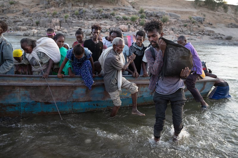 Ethiopian refugees arrive by boat to Hamdayet, Sudan, in 2020. Before the conflict, there were about 309,000 refugees living in Khartoum, according to the UN Refugee Agency (UNHCR). Many were hoping to be chosen for legal resettlement to Western countries. Photograph: Tyler Hicks/New York Times
                      