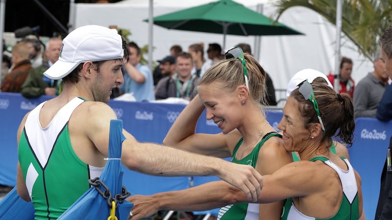 Claire Lambe and Sinead Lynch congratulate gold-medal-winning Irish rower  Paul O’Donovan at the Rio Olympics. Photograph:  Morgan Treacy/©INPHO