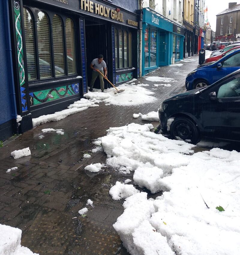 Cleaning up after hail in Enniscorthy last month. Photograph: Carlow Weather Twitter