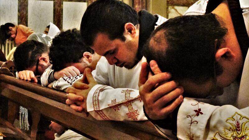 Men pray at Saints Maximus and Domadius Coptic Church on St Alphonsus Road, Dublin. Photograph: Shawn Pogatchnik