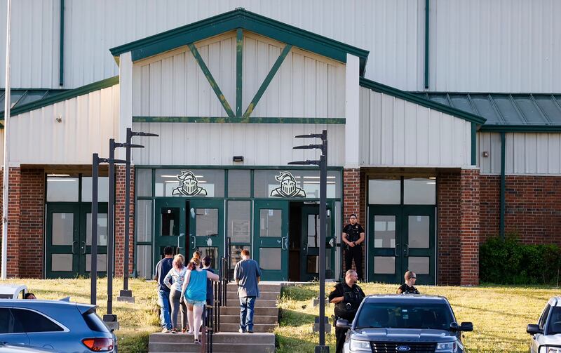 Law enforcement stand outside  Henryetta High School as people arrive for a vigil. Photograph: The Oklahoman via AP