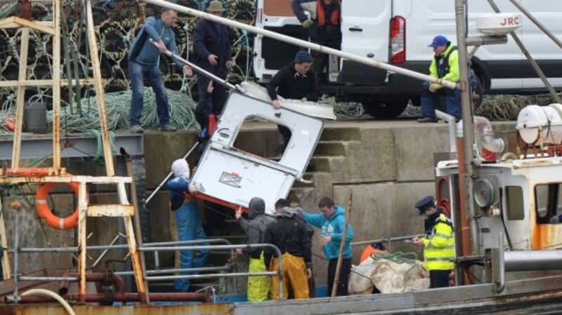 IDebris from Rescue 116 is taken from a trawler at Blacksod pier in Co Mayo. File Photograph: Dara Mac Dónaill