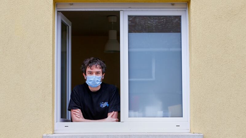 Jonathan Peterschmitt poses at his window during his home quarantine  in Bernwiller, near Mulhouse, France. Photograph: Denis Balibouse/Reuters