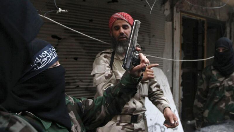 A female member of the Ahbab Al-Mustafa Battalion holds a gun as she undergoes military training in Aleppo’s Salaheddine district. Photograph: Muzaffar Salman/Reuters