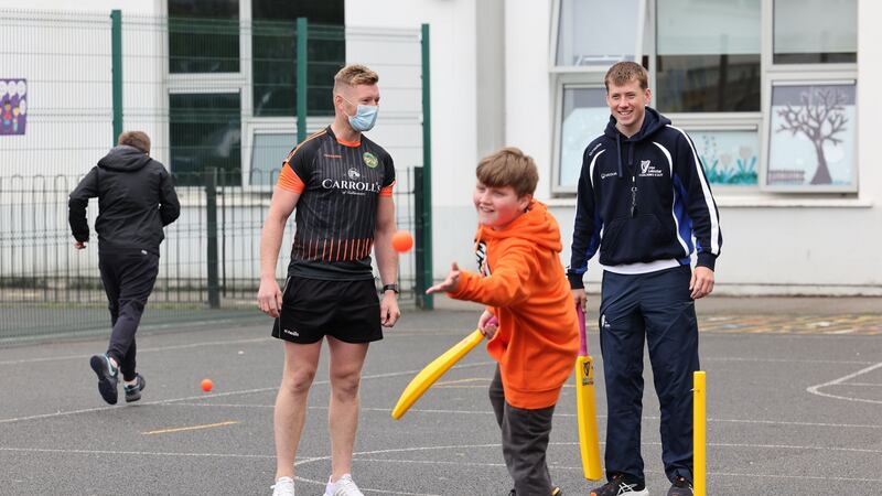 Gerry Spollen  with cricket coach Mitchell Thompson at Tyrrelstown Educate Together. Photograph: Alan Betson/The Irish Times