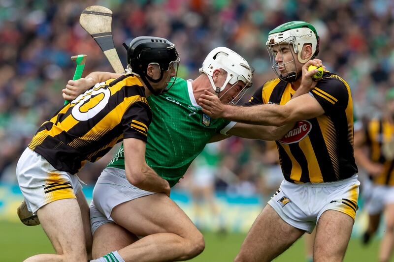 Kilkenny’s Tom Phelan and Paddy Deegan surround Kyle Hayes of Limerick. Photograph: Morgan Treacy/Inpho
