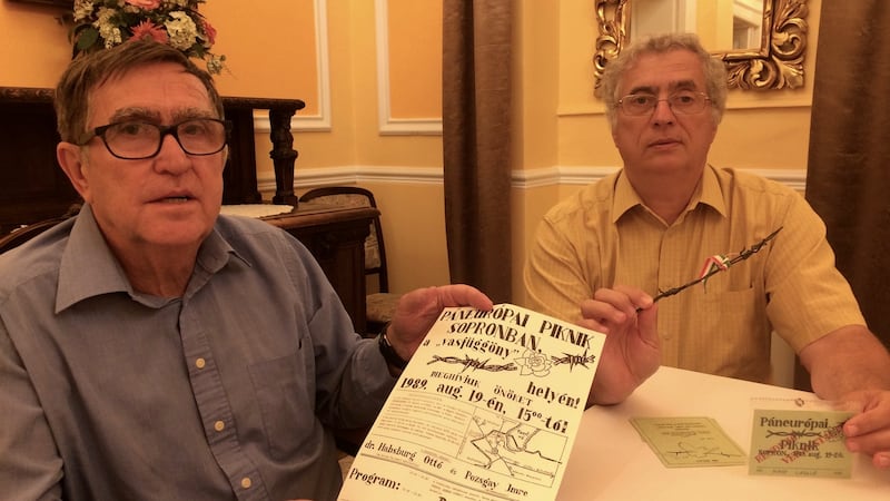 Laszlo Magas (left) and Laszlo Nagy, two organisers of the August 1989 Pan-European Picnic on the Hungary-Austria border. Magas holds a flyer for the picnic and Nagy a piece of barbed wire from the border fence. Photograph: Daniel McLaughlin