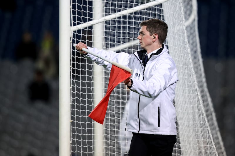 An umpire waves a red flag to signal a 2-point score. Photograph: Ben Brady/Inpho