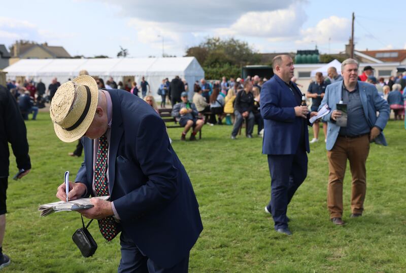 A racegoer consults his newspaper at Laytown. Photograph: Dara Mac Dónaill/The Irish Times