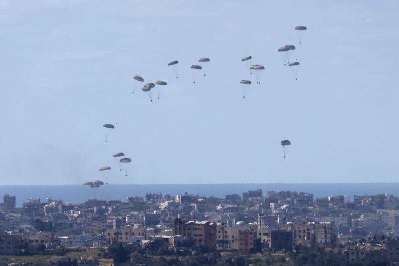 Humanitarian aid being airdropped by an unidentified military transport aircraft above the northern Gaza Strip on Sunday. Photograph: Abir Sultan/EPA