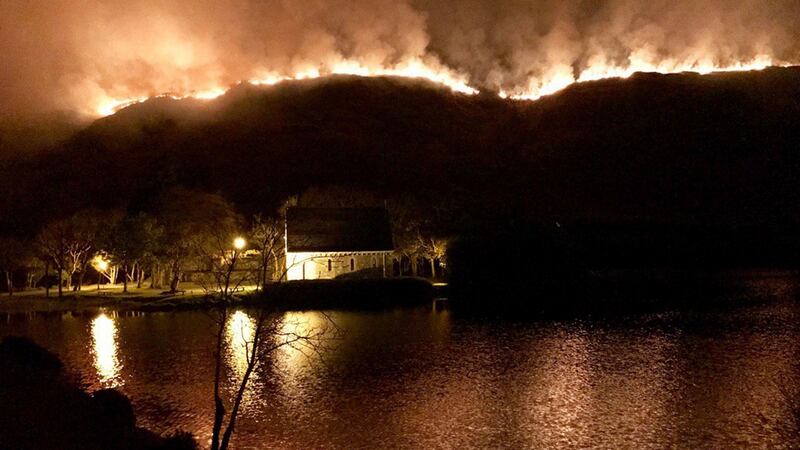 A gorse fire in Gougane Barra valley Co Cork, covering some 4km  at its peak,  burnt out “the entire middle section” of a scenic valley, according to a rural hotel boss. More than 30 firefighters tackled the inferno through the night, protecting a house and “a large area of forestry”, believed to be some 300 acres, the service said. Photograph:  Neil Lucey/PA WireNOTE