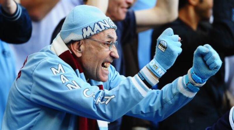 A Manchester City fan celebrates  at the Etihad Stadium.  Photograph: Laurence Griffiths/Getty Images