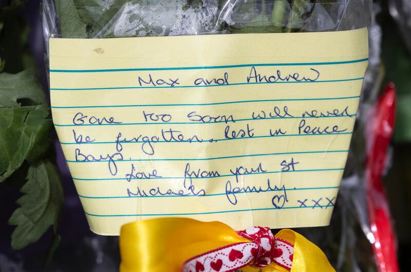 A message with a floral tribute this week at the entrance to St Michael's College for the families of  Andrew O'Donnell and Max Wall. Photograph: Colin Keegan/Collins Dublin