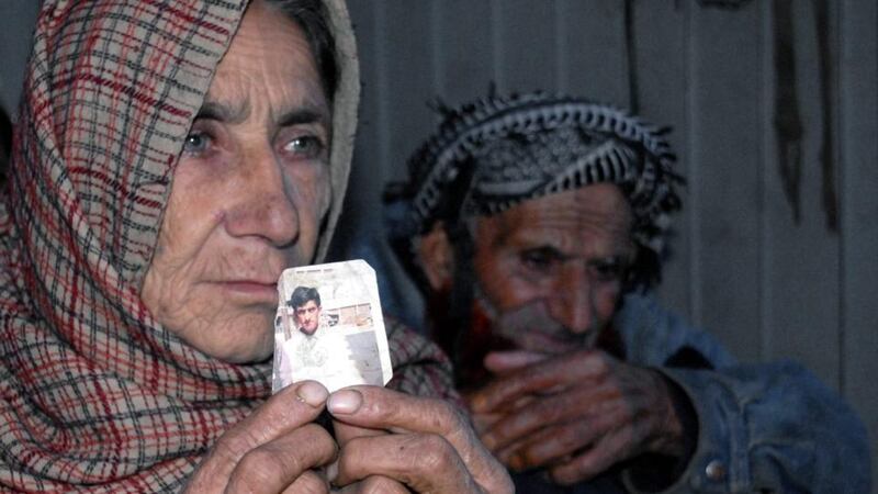 Makhni Bibi (left) and Shahazullah the parents of Shafqat Hussain who is on a death row, showing Hussain’s photograph. Hussain’s family and lawyer said he was 14 years old at the time of crime and trial, which should carry a maximum sentence of life imprisonment. Photograph: Stringer/EPA