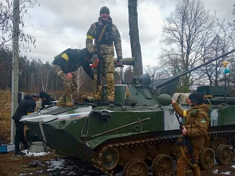 Vitaliy Huk and Ukrainian comrades on a Russian armoured vehicle seized near Bucha earlier this year. Photograph courtesy of Vitaliy Huk.