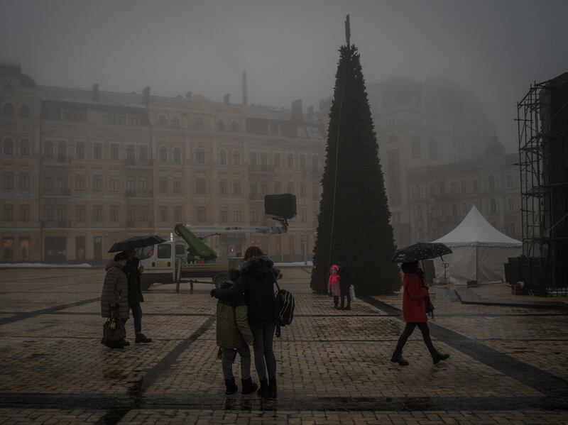 Workers install a Christmas tree in central Kyiv, Ukraine, on Saturday. Photograph: Laura Boushnak/The New York Times