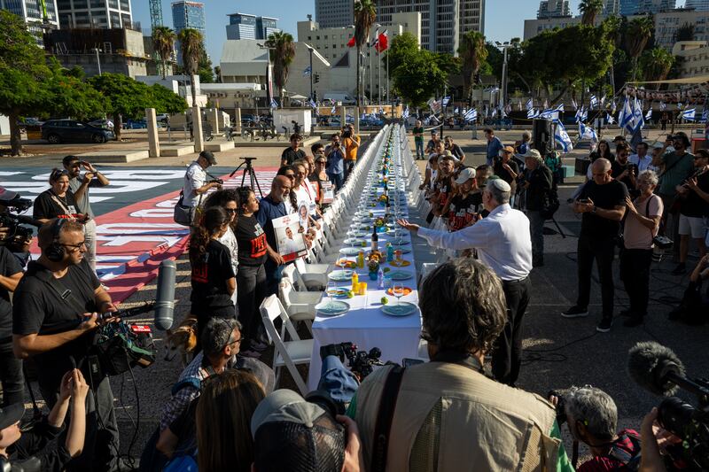 Families of hostages held by Hamas in the Gaza Strip participate in a  Kabalat Shabbat (welcoming the Shabbat) prayer service on Friday next to a 'Shabbat Dinner' table set up in the Tel Aviv museum plaza, with 200 empty seats representing the hostages and missing people, in Tel Aviv, Israel. Photograph: Alexi J Rosenfeld/Getty