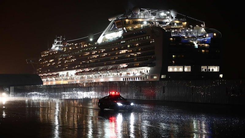 A police car drives past the Diamond Princess cruise shipat Yokohama port in Japan on February 16th. Photograph:  Behrouz Mehri/AFP via Getty Images