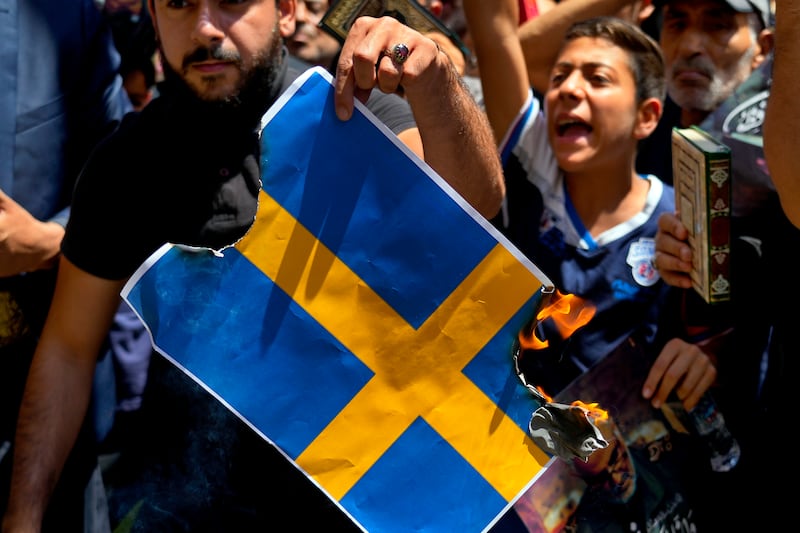 Hezbollah supporters burn the Swedish flag in Beirut. Photograph: Bilal Hussein/AP 