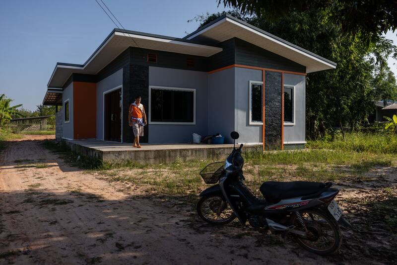 Pornchai Angkaew visits the house being built with his son Anucha Angkaew’s earnings from farm work in Israel. Photograph: Lauren Decicca/New York Times
                      